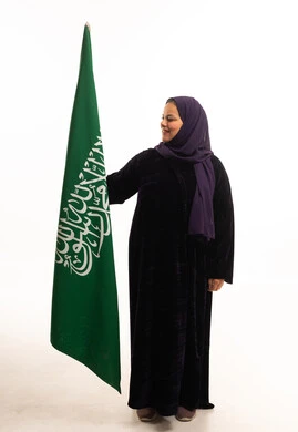 Saudi Woman in Abaya Holding Saudi Arabia Flag