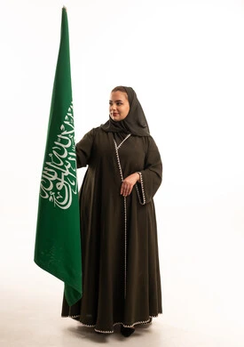 Saudi Woman Holding National Flag in Studio