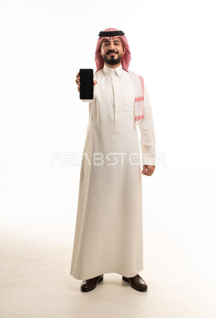 Saudi Man in Traditional Thobe Holding Smartphone