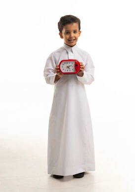 Saudi Boy in White Thobe Holding Red Alarm Clock