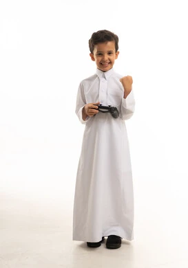 Saudi Boy in White Thobe Holding Game Controller
