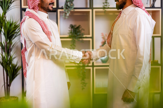 صوره لرجلان عربيان سعوديان خليجيان يتصافحان بحرارة , اتفاقية عمل , صفقة عمل , خطة عمل جديده , نجاح صفقة عمل جديده , شركاء عمل , رجال أعمال , بيئة عمل سعودي .