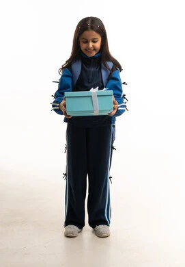 Saudi Girl in School Sports Uniform Holding Gift