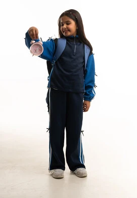 Saudi Schoolgirl in Uniform Holding Pink Alarm Clock