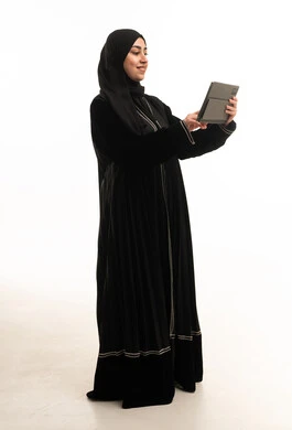 Saudi Woman in Black Abaya Using Tablet on White