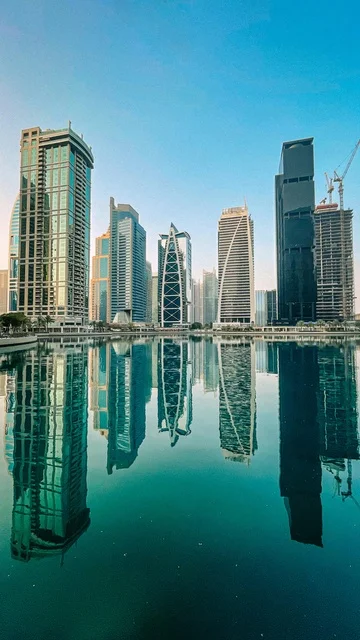 Modern Dubai Skyscrapers Reflecting in Calm Water