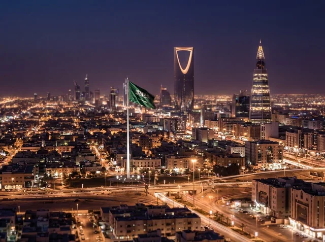 Riyadh Skyline at Night with Saudi Flag and Skyscrapers