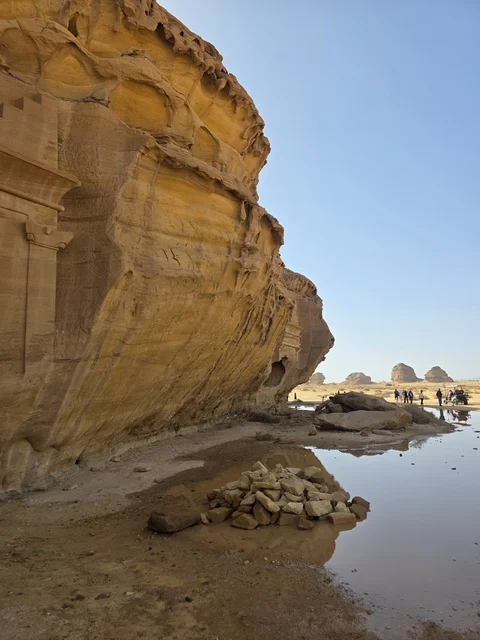 Natural sandy rock formations in the Al-Ula desert in the Kingdom of Saudi Arabia. Daylight highlights the geological terrain and sandy land under a clear sky, tourism in Al-Ula.