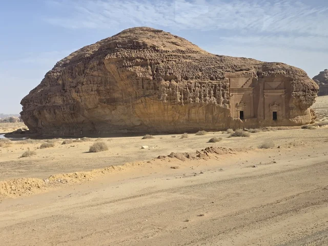 Natural sandy rock formations in the Al-Ula desert in the Kingdom of Saudi Arabia. Daylight highlights the geological terrain and sandy land under a clear sky, tourism in Al-Ula.