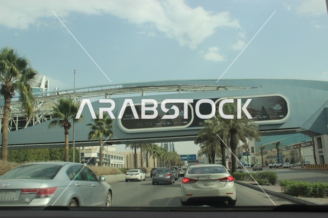 Traffic on Riyadh Highway Under Modern Pedestrian Bridge