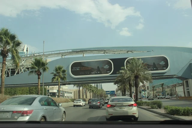 Traffic on Riyadh Highway Under Modern Pedestrian Bridge