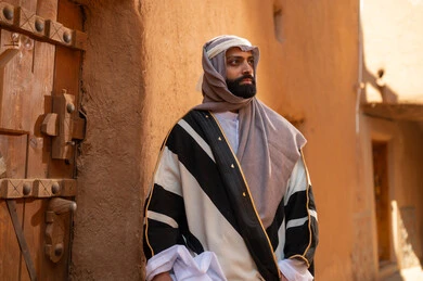 Saudi Man in Traditional Bisht at Historical Mud Village