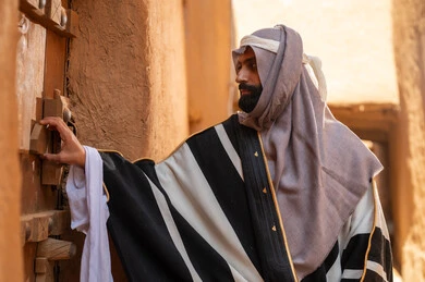 Saudi Man in Traditional Bisht at Heritage Site