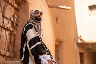 Saudi Man in Traditional Dress at Historical Mud Site