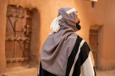 Saudi Man in Traditional Heritage Clothing and Architecture