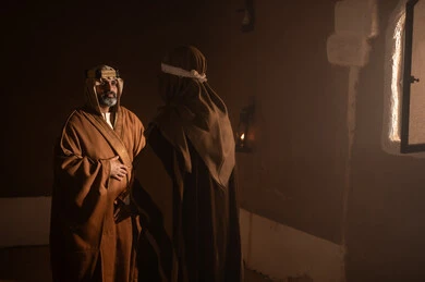 Saudi Men in Traditional Bisht Inside Historical Mud House