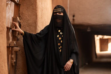 Saudi Woman in Traditional Abaya at Heritage Site