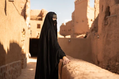 Saudi Woman in Traditional Abaya at Heritage Site