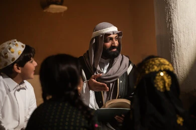 Saudi Man Storytelling to Children in Heritage House