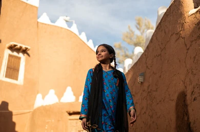 Saudi Girl in Traditional Dress at Mud Heritage Village