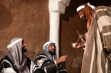 Saudi Men Pouring Arabic Coffee in Heritage Mud House