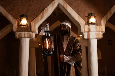 Saudi Man in Heritage Building Holding Kerosene Lantern