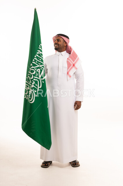 Saudi Man Holding National Flag in Traditional Attire