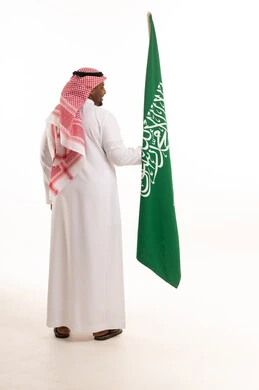 Saudi Man Holding National Flag on White Background