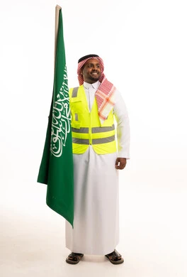 Saudi Man in Safety Vest Holding National Flag