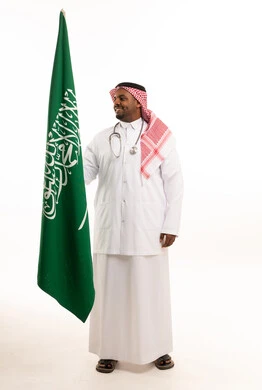 Saudi Doctor Holding Saudi Flag on White Background