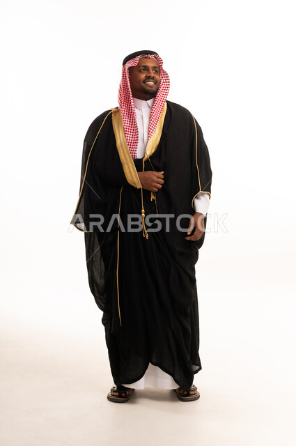 Saudi Man in Traditional Black Bisht and Red Ghutra