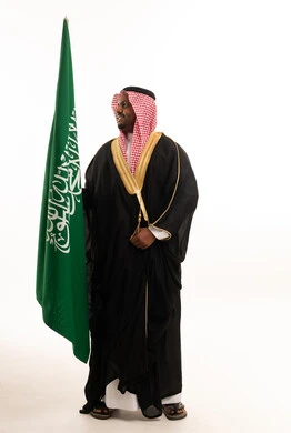 Saudi Man in Traditional Bisht with Saudi Flag