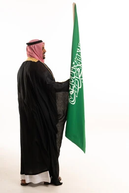Saudi Arabian Man with National Flag in Traditional Bisht