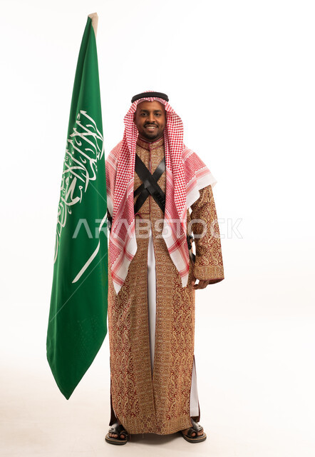 Saudi Man Holding National Flag in Traditional Attire