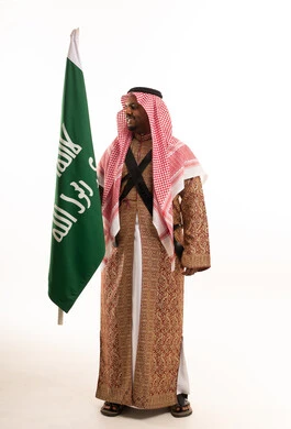 Saudi Man in Traditional Ardah Dress with National Flag