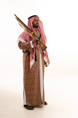 Saudi Man in Traditional Dress Holding Antique Rifle
