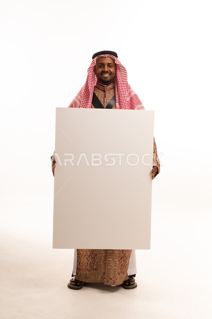 Saudi Man in Traditional Dress Holding Blank Board