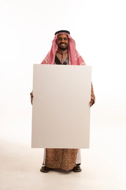 Saudi Man in Traditional Dress Holding Blank Board