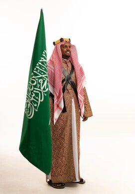 Saudi Man in Traditional Heritage Dress with Saudi Flag