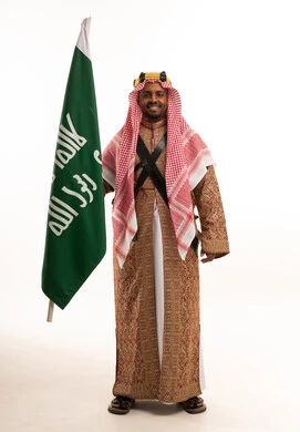 Saudi Man Holding National Flag in Traditional Dress
