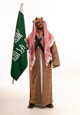 Saudi Man in Traditional Ardha Attire with Flag