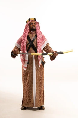 Saudi Man in Traditional Attire Holding Sword