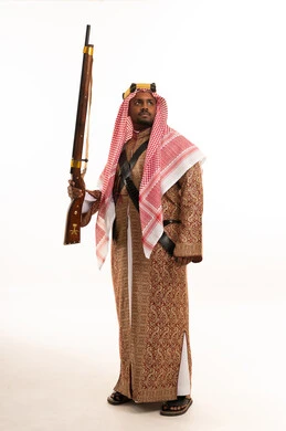 Saudi Man in Traditional Dress Holding Antique Rifle