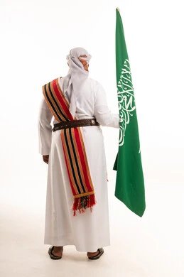 Saudi Man with National Flag in Traditional Dress