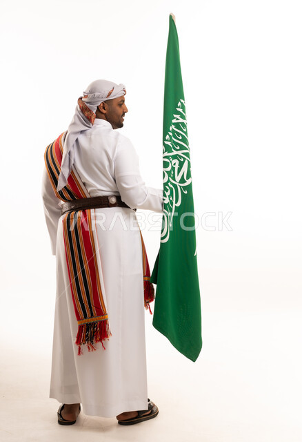 Saudi Man in Traditional Ardha Dress Holding Flag