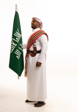 Saudi Man in Southern Traditional Dress Holding Flag