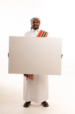 Omani Man in Traditional Dress Holding Blank White Board