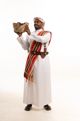 Saudi Man in Traditional Southern Dress Holding Basket