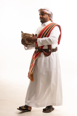Saudi Man in Traditional Southern Attire with Basket