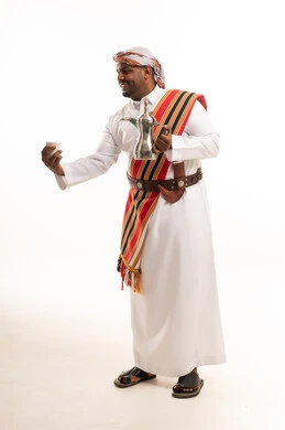 Omani Man in Traditional Dress Holding Coffee Dallah